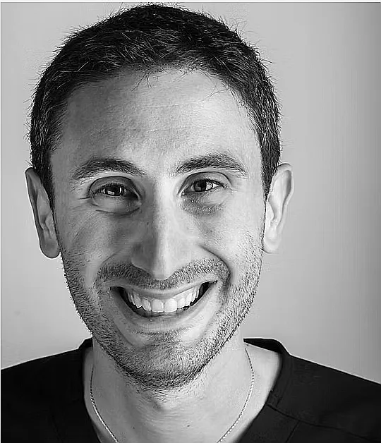 Dr. Marco Bergamini, smiling, in a black-and-white portrait