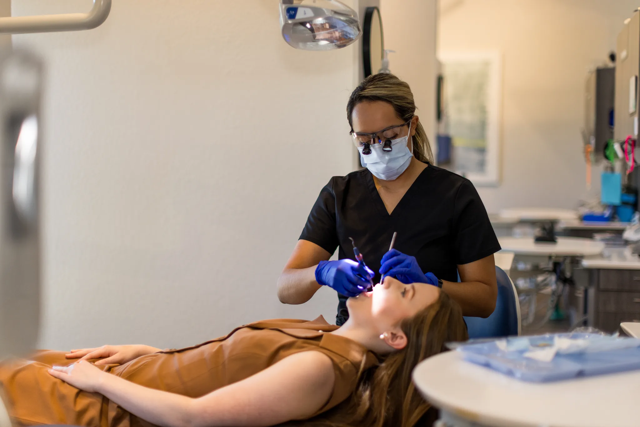 A dentist examining a patient's teeth during a routine checkup