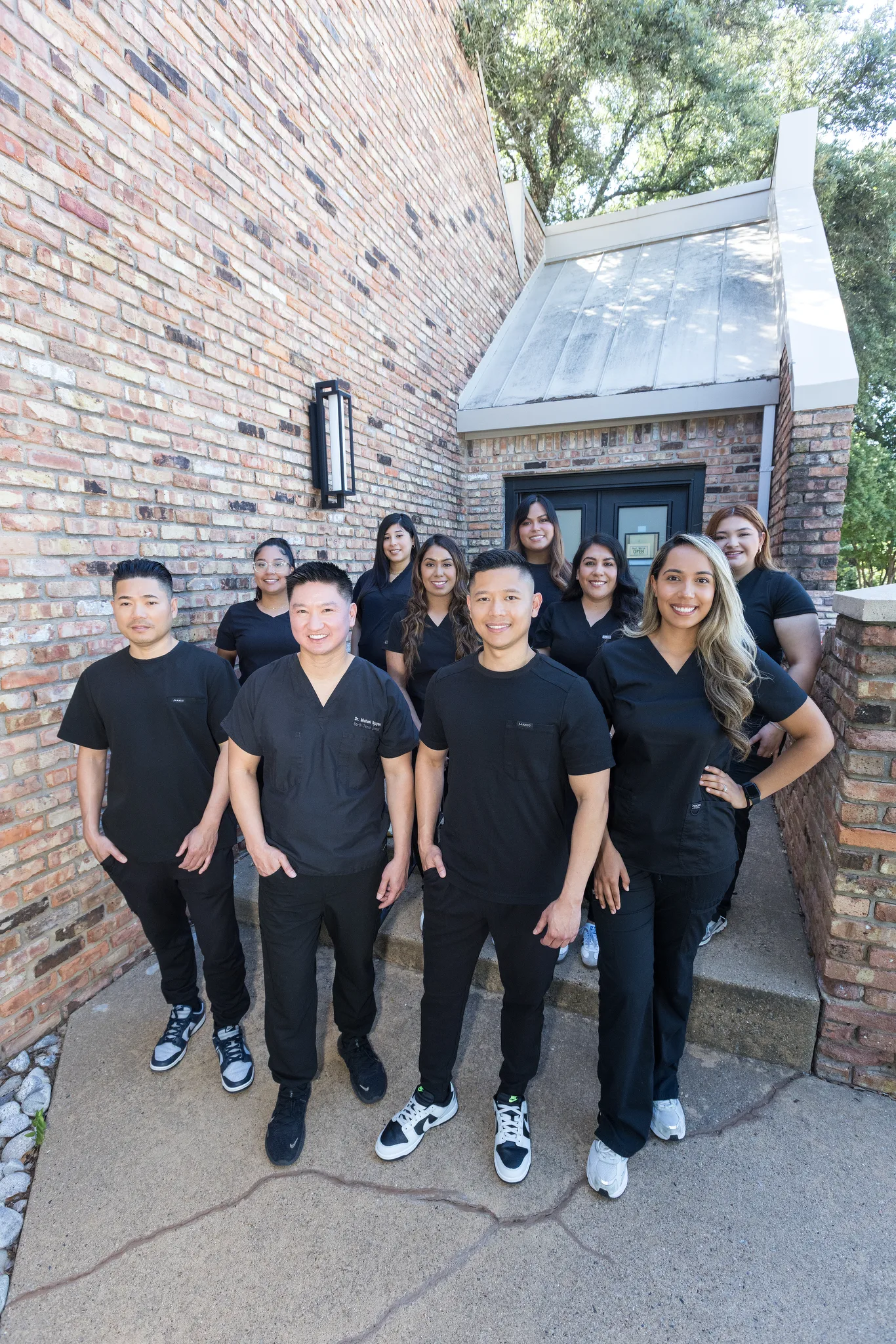 The Precision Dental Care team at the practice entrance