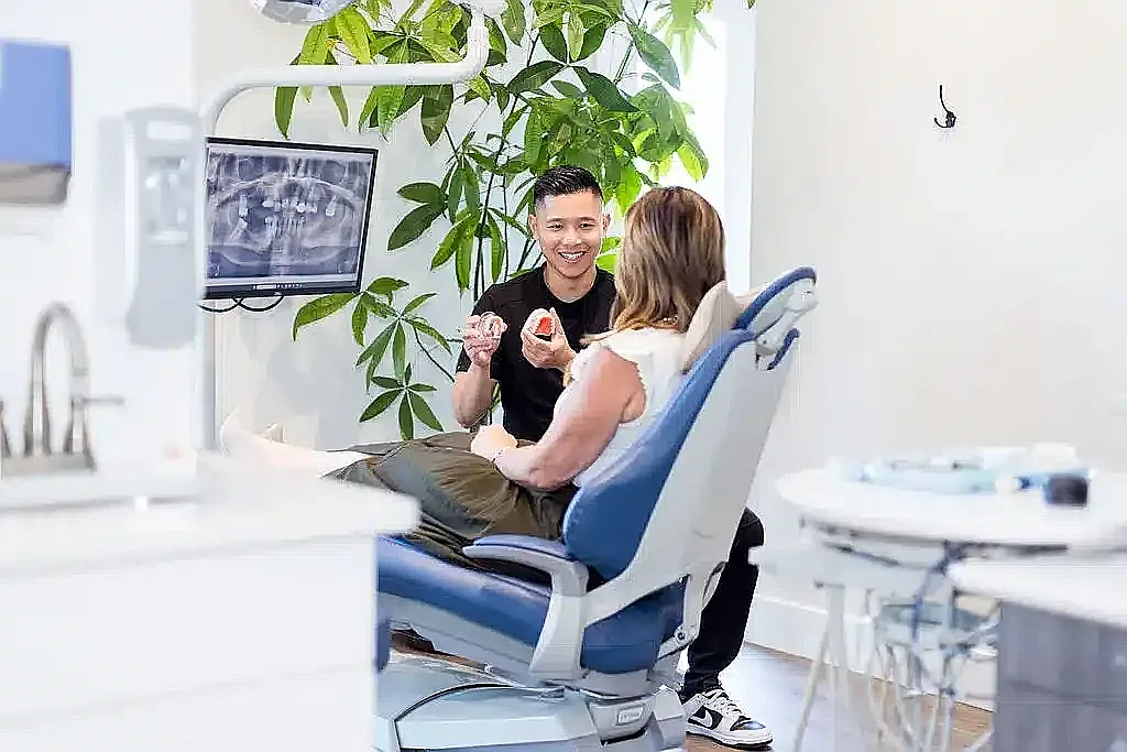 Dentist and patient reviewing X-rays on the operatory screen