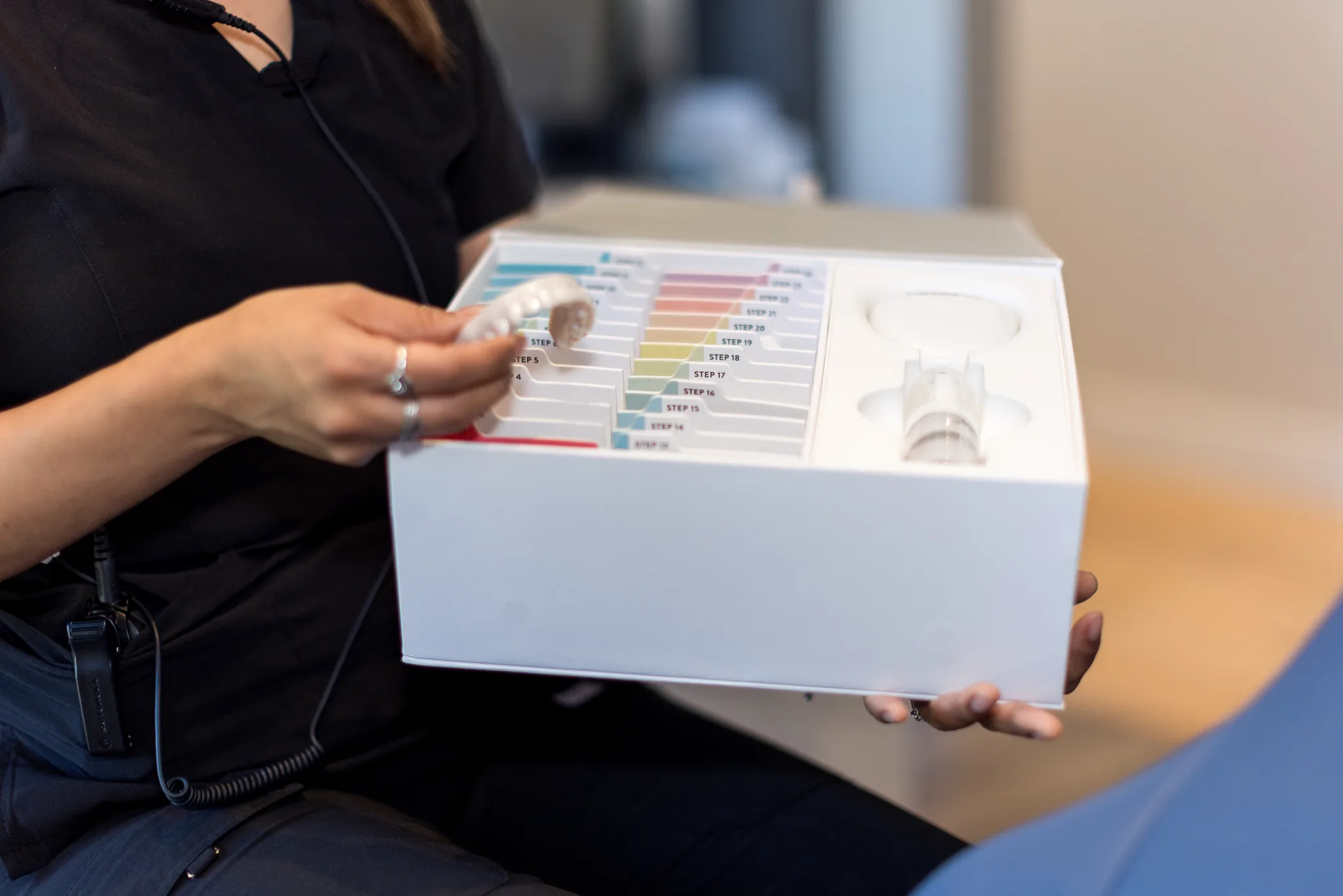 A team member opening the Candid clear aligner starter kit for a patient