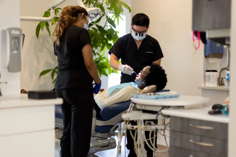 A dentist and assistant working together on a patient during a cosmetic appointment