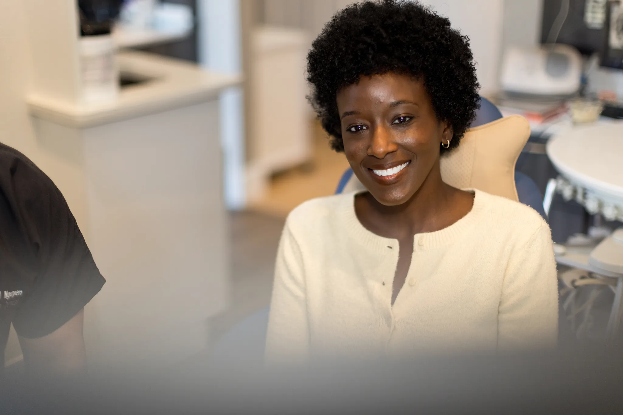 A patient smiling in the operatory at Precision Dental Care