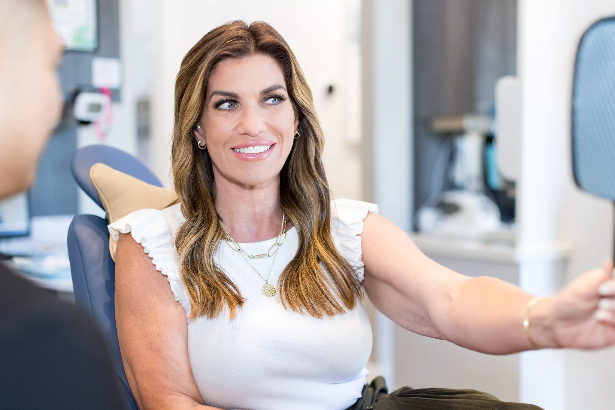 A patient smiling in the chair after treatment