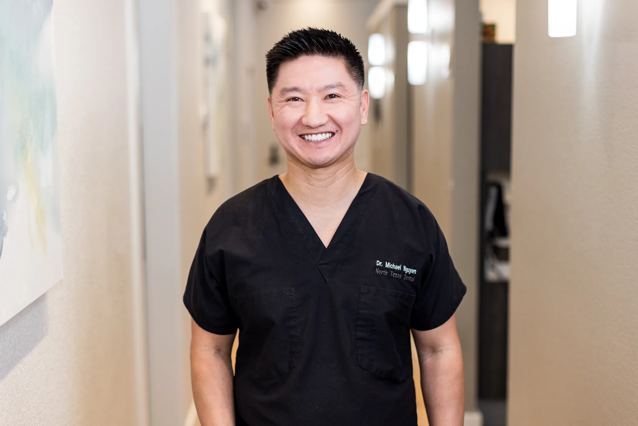 Dr. Michael Nguyen in the practice hallway at Precision Dental Care
