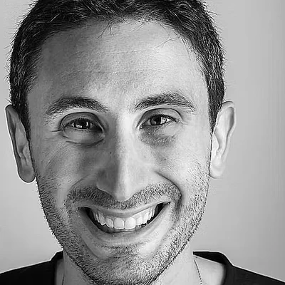 Dr. Marco Bergamini, smiling, in a black-and-white portrait