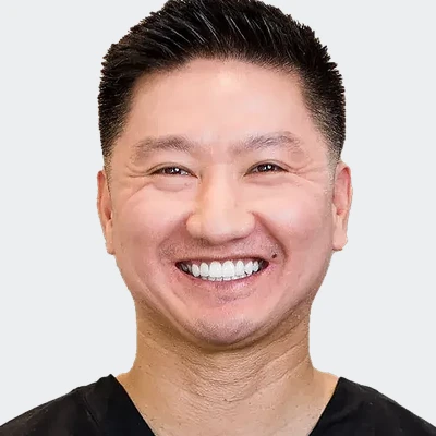 Dr. Michael Nguyen, smiling, in black scrubs